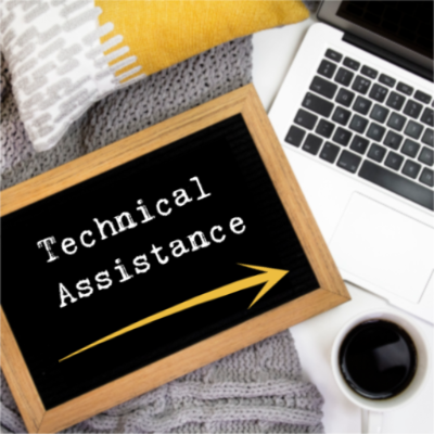 Cozy pillow with computer and coffee cup with letterboard that says 'Technical Assistance' 
